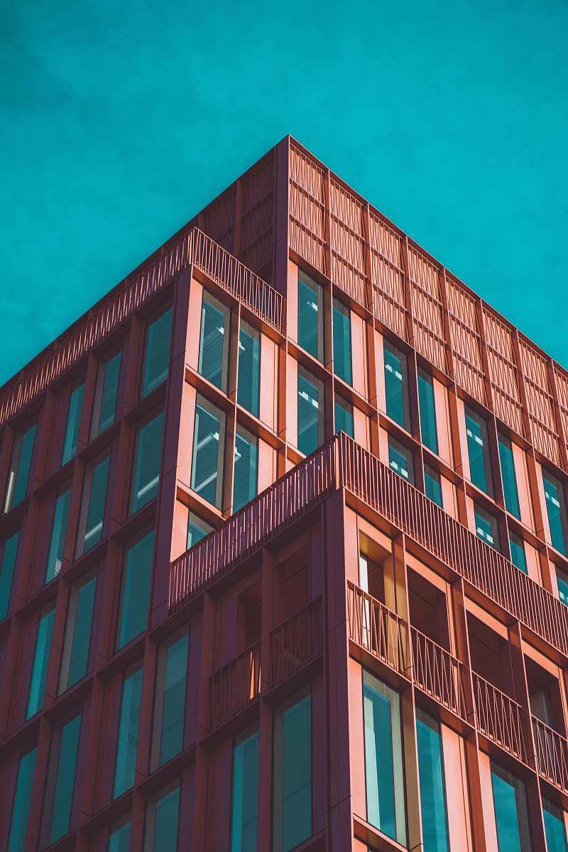 kings cross architectural photography of concrete building under clear blue sky london
